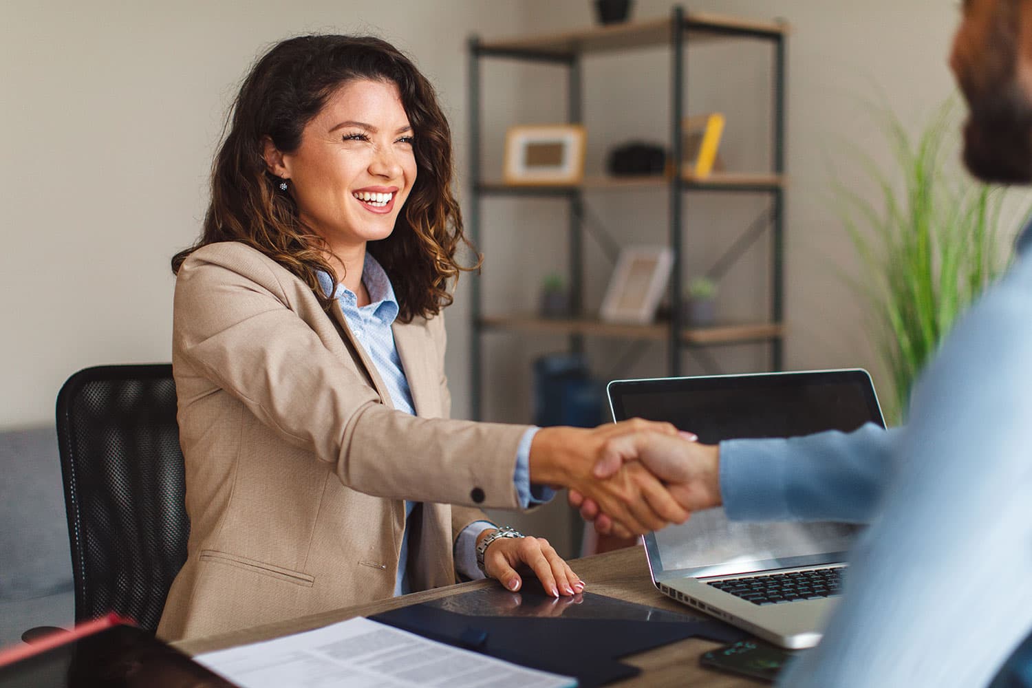 Business woman shaking hands with loan officer