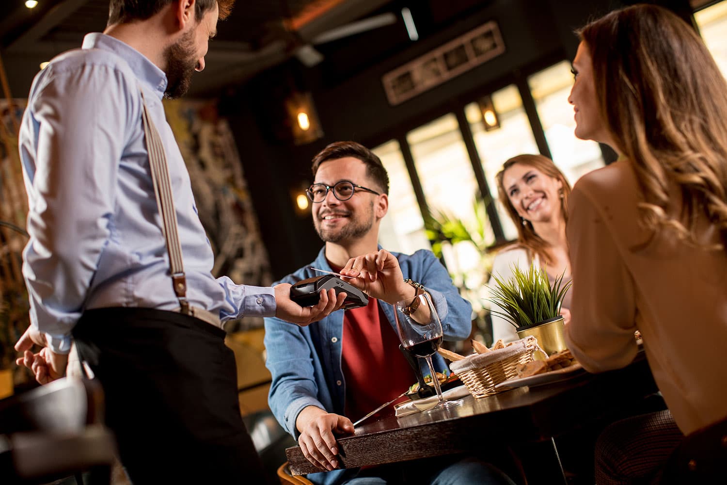 man paying with credit card at restaurant